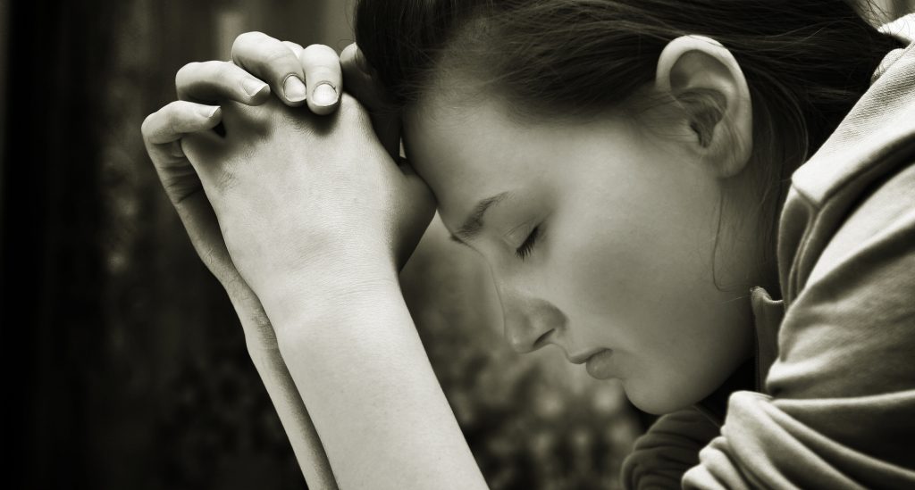 Black and white photo of person praying