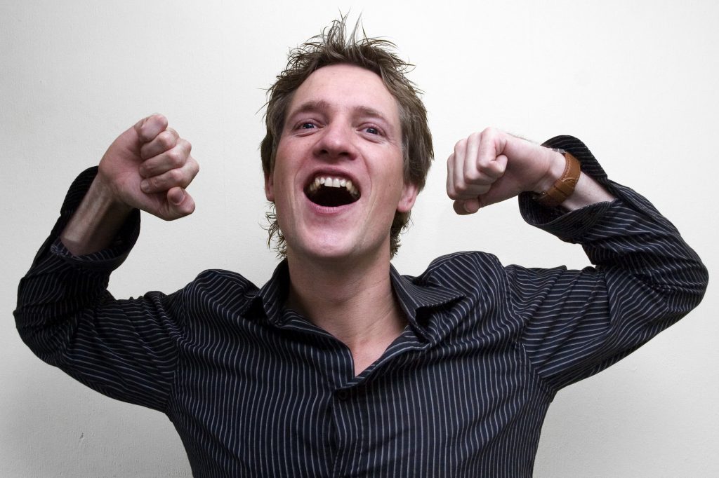 Excited man with arms up