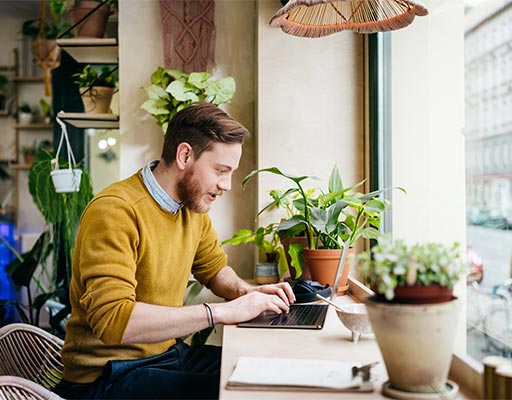 Man using laptop with spam protection software