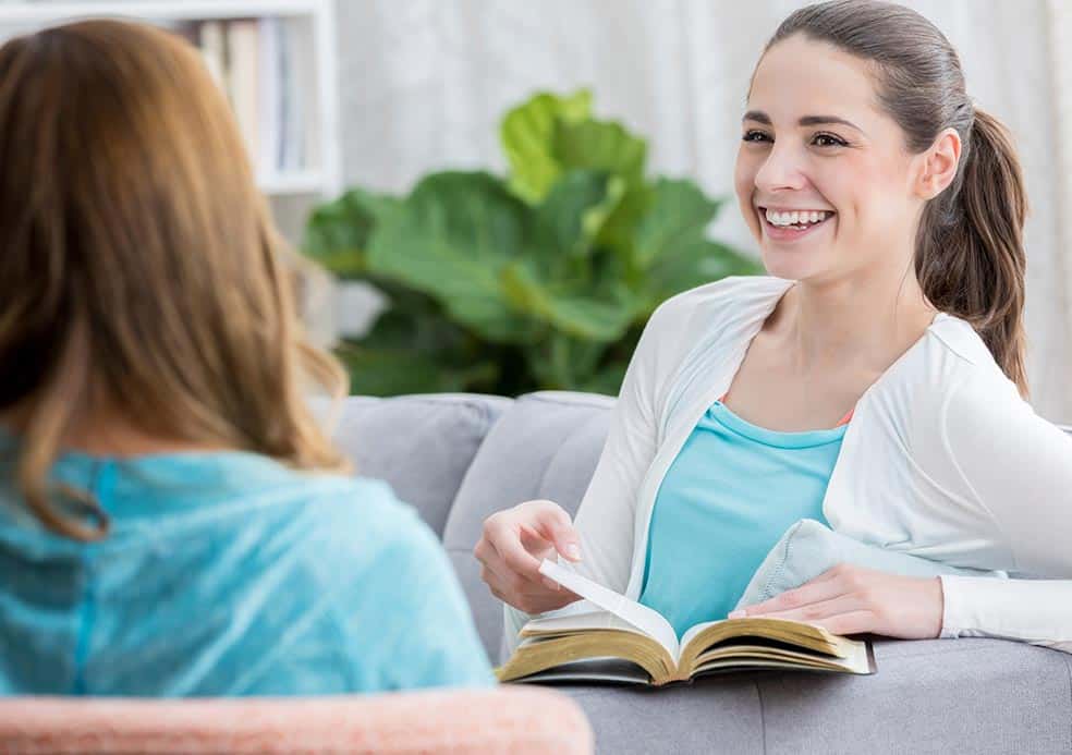 Girl smiling with an open book talking about web host services