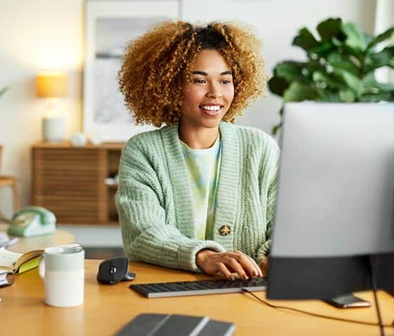 Woman using laptop on a christian web hosting company